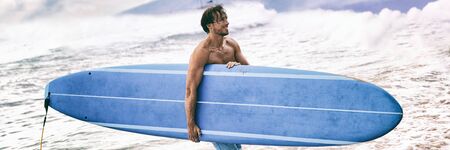 Surfer coming out of ocean walking in waves after surf session surfing lifestyle in Maui, Hawaii,...