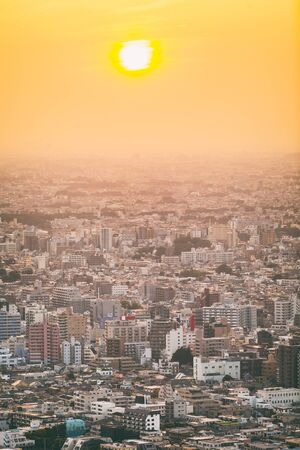 Tokyo cityscape background Japan travel lifestyle. Morning view of the city with hazy sun through clouds, view from the Tokyo Tower.の写真素材