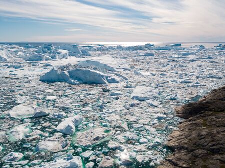 Iceberg and ice from glacier in arctic nature landscape in Greenland. Aerial drone photo of icebergs...