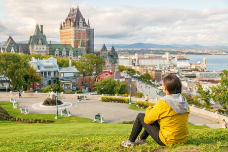 Canada travel Quebec city tourist enjoying view of Chateau Frontenac castle and St. Lawrence river in background. Autumn traveling holiday people lifestyle.の写真素材