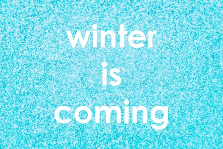 Winter snow texture blue background with small snowflakes for christmas concept, copy space for text message signs or advertisement. Frozen frost on cold window.の写真素材