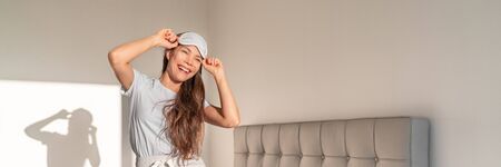 Happy woman dancing on bed wearing sleep mask banner panorama. Bedroom young girl lifestyle in...