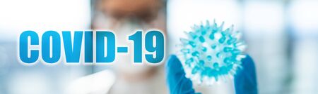 COVID-19 Coronavirus medical research laboratory researcher showing corona virus model panoramic banner with text title.の写真素材