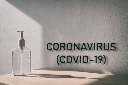 Coronavirus (COVID-19) text sign with hand sanitizer bottle background for global pandemic of corona virus outbreak.の写真素材
