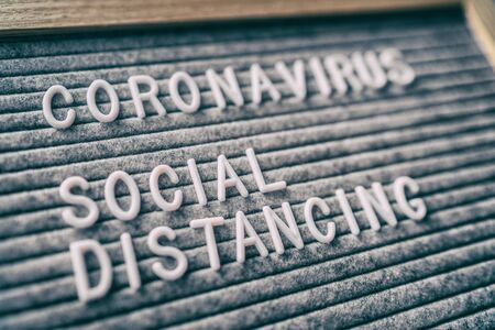 Coronavirus SOCIAL DISTANCING message board with text.の写真素材