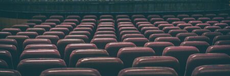 Coronavirus closure of public spaces such as cinemas, theatres, city lockdown. Retail businesses shut down. Banner panoramic background of empty concert seats.の写真素材