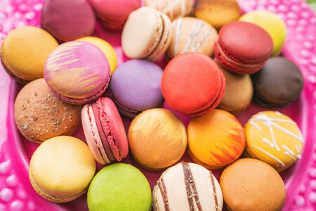 Many macarons closeup on table. Numerous colorful french macaron pastries.の写真素材