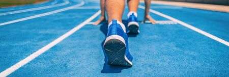 Sprinter fit man waiting for start of race on running tracks at outdoor stadium. Sport and fitness...