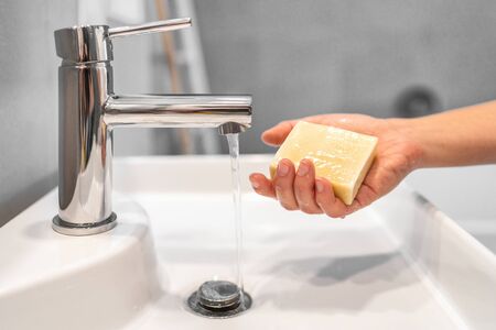 Corona virus washing hands with soap bar at home COVID-19 prevention. Hand hygiene for coronavirus outbreak. Protection by hand wash handwashing.の写真素材