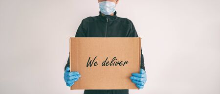 Home delivery WE DELIVER sign on cardboard box banner. Food grocery package online shopping man...