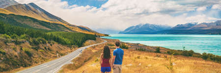 New Zealand travel people looking at Mount Cook Aoraki far in the landscape. Couple tourists walking at Peters lookout, banner panorama copy space on background.の写真素材