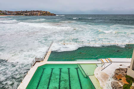 Sydney Bondi beach swimming pool. Australia travel. Ocean waves over famous popular tourist attraction on the coast.の写真素材