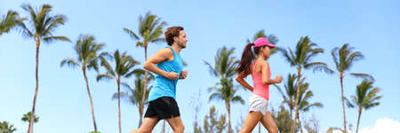 Healthy runners couple running lifestyle banner. Sport fitness people jogging together in summer...