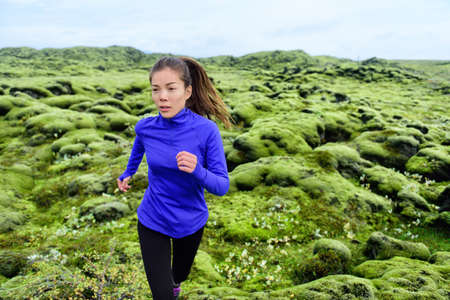 Athlete trail runner - running woman exercising. Fit female sport fitness model training jogging outdoors living healthy lifestyle in beautiful nature, Iceland.の写真素材