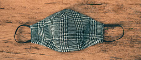 Fashion fabric face mask in plaid houndstooh pattern. Stylish masks for outfits during autumn winter...