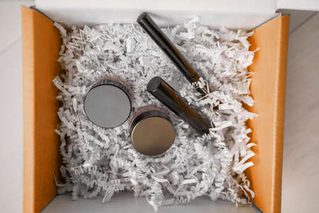 Makeup products online shopping delivery box at home - Gift box containing mascara, eyeliner,...