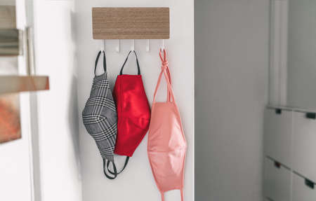 Masks at home what to wear to fit with fashion outfit before going out of the door. Hanging face mask selection for coronavirus prevention.の写真素材