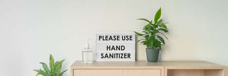 Coronavirus business sign asking customers to disinfect hands with hand sanitizer upon entrance of...