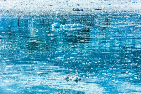Alaska glacier water texture of melting icebergs nature travel background. Copy space on blue...