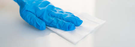 Surface cleaning against spreading of coronavirus person wearing gloves with antibacterial...