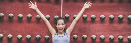 Happy Asian woman excited welcoming with arms up in front of old door of Asia travel temple banner panorama background smiling people lifestyle. Chinese girl tourist enjoying summer holidaysの写真素材