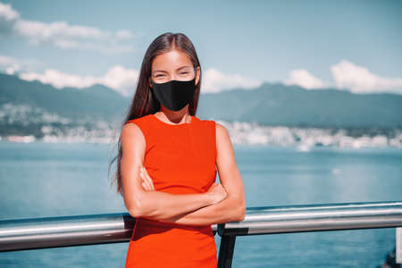 Asian businesswoman wearing face mask as coronavirus prevention. Confident multiracial business lady...