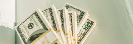 Cash wads lying on white background banner. Panoramic of stacks of us dollar bills, money concept