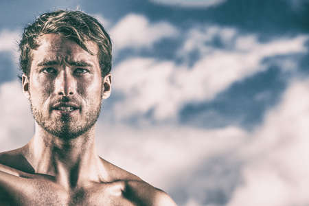 Sexy attractive male model handsome man face portrait. Young caucasian in his 30s high contrast process showing wrinkles and skin texture. Skincare men beauty.の写真素材