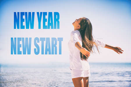 New Year 2019 resolution. New Start well-being happy Asian woman feeling free, happy emotion. Girl with open arms in happiness on summer beach vacation.の写真素材