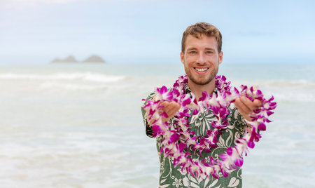 Hawaii welcome caucasian man in hawaiian shirt welcoming tourist giving lei of fresh flowers as aloha spirit gesture on Hawaii beach for luau party. Travel vacation destinationの写真素材