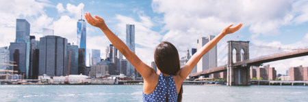 Success in business career in New York City. Panoramic banner. Aspirational Happy free woman cheering by NYC New York city skyline with arms up. Goal achievement carefree freedom successful personの写真素材