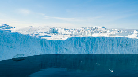 Giant iceberg. Global warming and climate change concept. Icebergs in Disko Bay on greenland in Ilulissat icefjord from melting glacier Sermeq Kujalleq Glacier, Jakobhavns Glacier. Aerial drone imageの写真素材
