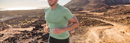 Trail run runner man training for triathlon. Banner of running athlete outdoor on mountain path....