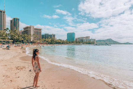 Waikiki beach travel lifestyle. Tourist woman walking in Honolulu, Hawaii during winter holidays. Summer vacation destinationの写真素材