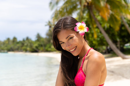 Skincare woman on luxury travel beach vacation. Portrait of beautiful woman in bikini smiling, French Polynesia. Image is completely unretouched and model is without makeup. Real people. Raw Imageの写真素材