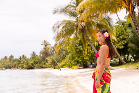 French Polynesia photo of woman wearing traditional pareo and Bikini relaxing on perfect beach on Bora Bora vacation travel. Completely unretouched, model has no makeup. Real people. Raw Imageの写真素材