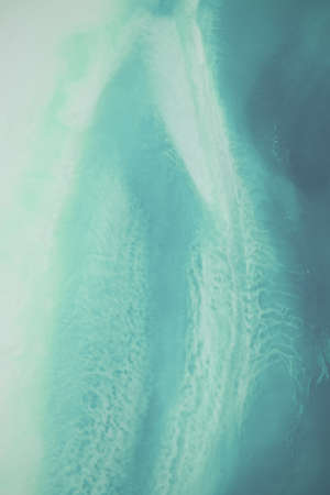 Liquid flow texture paint. modern art background. abstract epoxy resin painting. Green waves with...