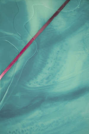Liquid flow texture paint. modern art background. abstract epoxy resin painting. Green waves with...