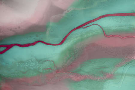 Liquid flow texture paint. modern art background. abstract epoxy resin painting. Green waves with...