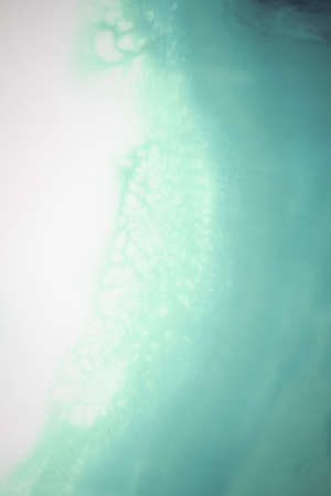 Liquid flow texture paint. modern art background. abstract epoxy resin painting. Green waves with...