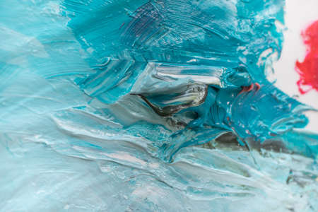 Oil painting in multicolored tones. Conceptual abstract closeup of a painting by oil and palette...