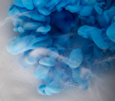 Abstract fluid acrylic painting. Marbled white abstract Ink cloud on blue background. Liquid marble pattern. Modern art.の写真素材