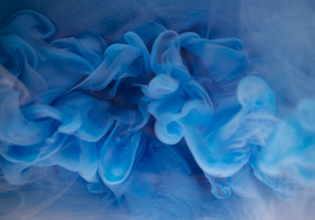 Abstract fluid acrylic painting. Marbled white abstract Ink cloud on blue background. Liquid marble pattern. Modern art.の写真素材