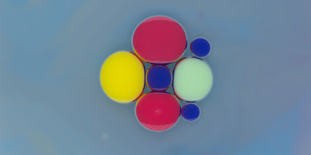 Colorful abstract arrangement of floating spheres in shades of red, yellow, blue, and green against...