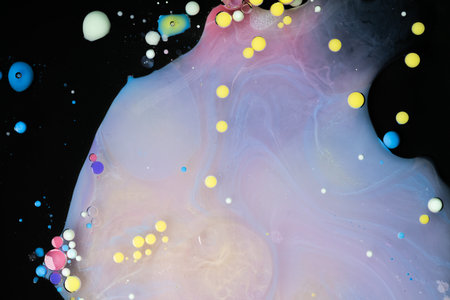 A myriad of oil droplets intermingling with water, creating a mesmerizing effect reminiscent of a galaxy.の写真素材