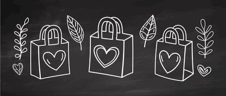 Eco friendly outline shopping bags with hearts and leaves on chalkboard backgroundのイラスト素材