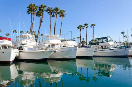 This is a photograph of boats moored in the Long Beach, California marina. の写真素材