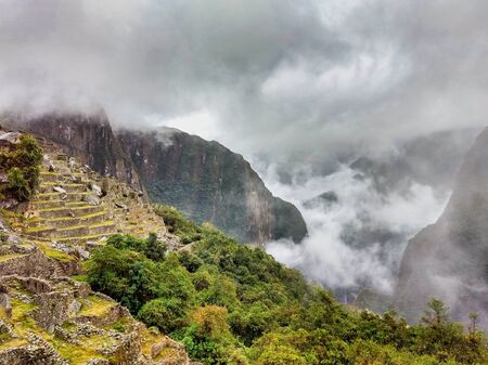 Dense fog, rain and clouds cover the world site of Machu Picchu, Peruの写真素材