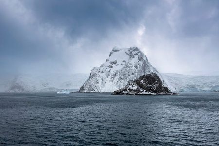 Antarctic landscape of Elephant Island in Antarctica with icebergs, snow, and mountains in the oceanの写真素材