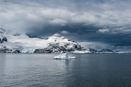 Antarctic landscape at Coronation Island in the South Orkneys in Antarctica with icebergs and mountains in cloudy weatherの写真素材